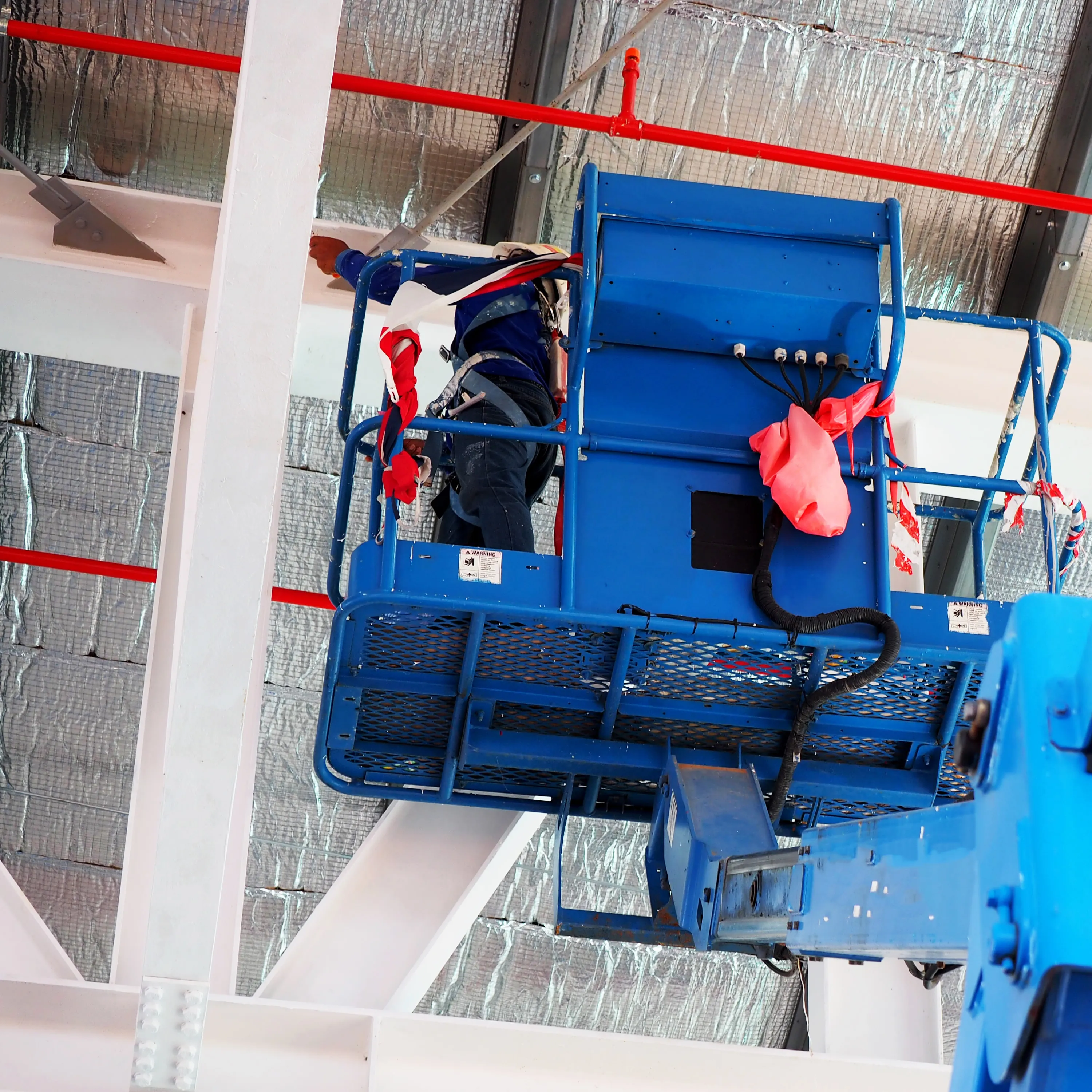 Cherry picker working on interior roofline